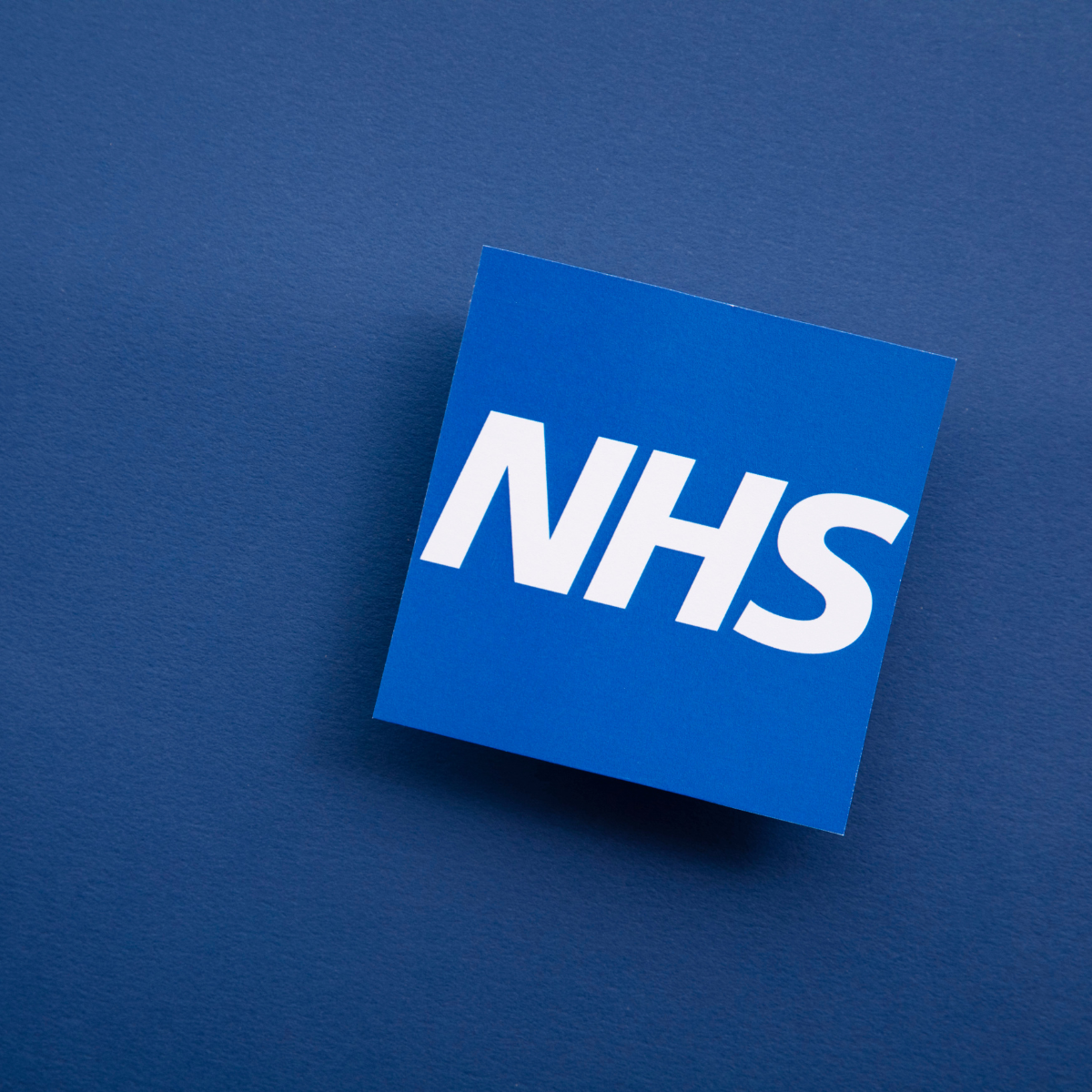 NHS logo on blue background